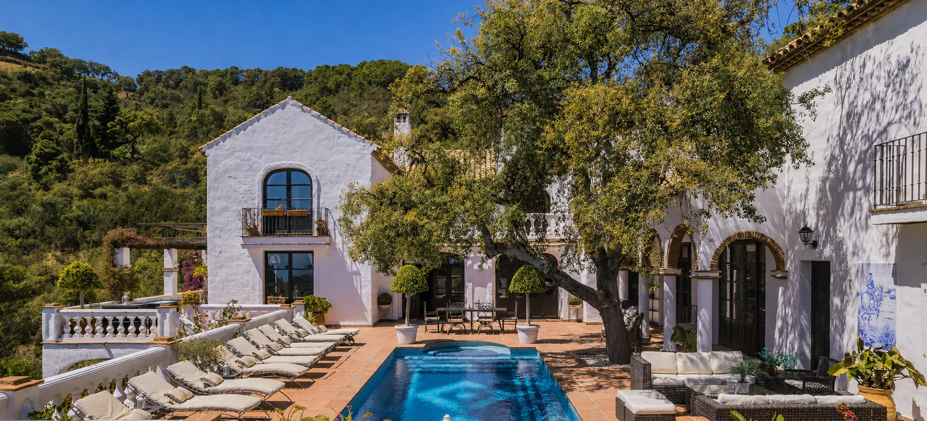 Andalusian-style home for sale in Benahavís with Mediterranean architecture and courtyard pool